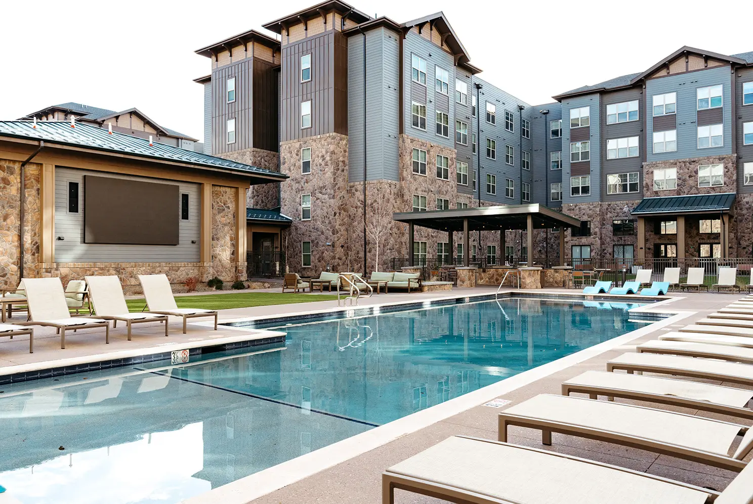 resort style pool surrounded by lounge chairs